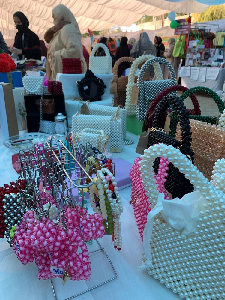 Bagilfashion handmade pearl and beaded bags displayed at a craft fair stall in Pakistan